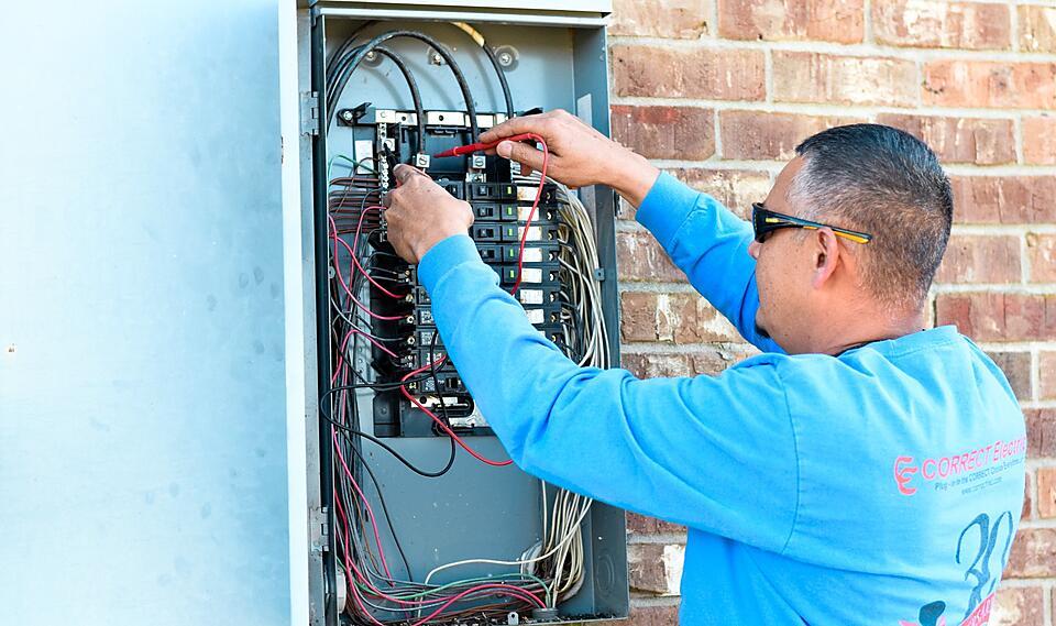 Correct Electric electrical contractor checking a breaker box