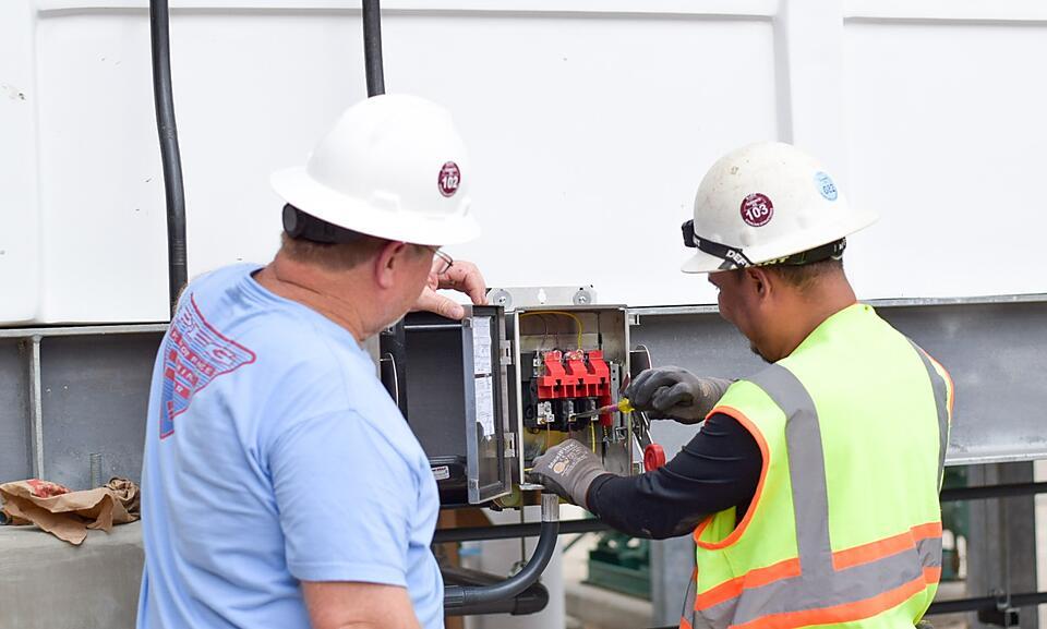 Correct Electric electrical contractor working on an industrial electrical system